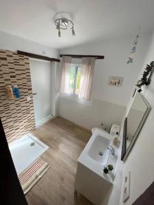 a white bathroom with a sink and a shower at Guest house with shared pool. in Coria del Río