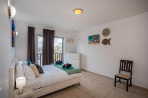 Ένα ή περισσότερα κρεβάτια σε δωμάτιο στο Palapa Beach Paradise