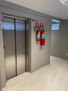 two fire hydrants on a wall in a fire station at APT Moderno na melhor Localização de João Pessoa! in João Pessoa