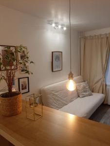 a bedroom with a bed and a table with a potted plant at New! Cozy Apartment with Free guarded parking in Riga