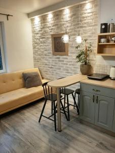a living room with a couch and a table at New! Cozy Apartment with Free guarded parking in Riga
