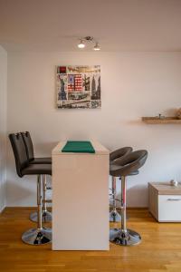 a barber shop with black chairs and a white counter at Apartment Central Fulpmes + free parking spot in Fulpmes