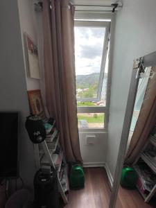 a room with a large window and a mirror at Departamento Talca , parque seminario in Talca