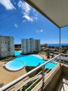 a view of the pool from the balcony of a apartment at Departamento Laguna Vista Oceano in Algarrobo