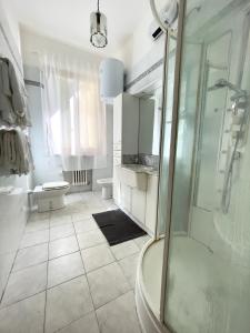 a white bathroom with a shower and a toilet at Appartamento Stella in Empoli