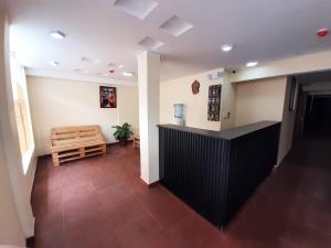 a room with a hallway with a counter and a bench at Mi casa in Latacunga