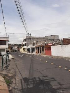 an empty street in an old town with buildings at Mi casa in Latacunga