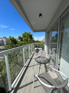a balcony with two chairs and a table on it at Modern and brigth studio in Palermo Hollywood in Buenos Aires