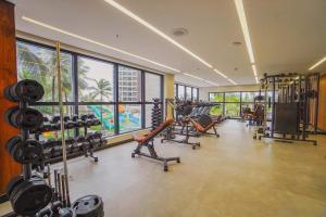 a gym with treadmills and machines in a building at Salinas Premium Resort A&D in Salinópolis