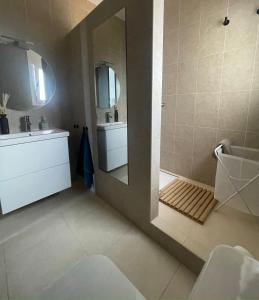 a bathroom with a sink and a shower with a mirror at Casa en el campo in Ventalló