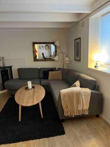 a living room with a couch and a table at Gimle Casa in Tromsø