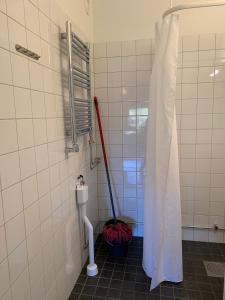 a bathroom with a mop and a toilet in a room at Home Inn SLV4 in Stockholm