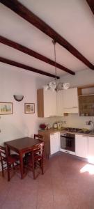 a kitchen with a wooden table and a dining room at Panigale90 in Bologna