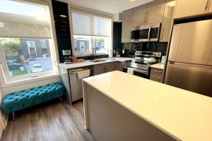 a kitchen with a large island in a kitchen at Exquisite, bright & modern condo. in Niagara Falls