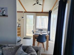 a living room with a table and a couch at Dog Friendly 8 Berth Lodge, 600 Yard's From The Beach In Hunstanton in Hunstanton