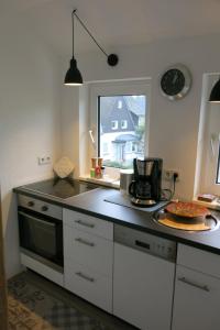 a kitchen with a counter top with a stove top oven at Ferienhaus Julius in Willingen