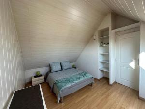 a small bedroom with a bed in a attic at Duplex F2 - proche GARE TGV in Mulhouse