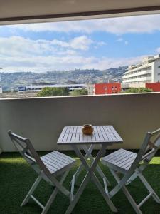 a table and two chairs on a balcony with a view at Aera in Nice