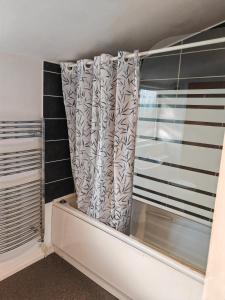 a curtain in a room with a window at Heads on Bed Pitsea Basildon Essex House with Free Parking Netflix & Wifi in Basildon