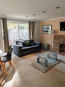 a living room with a couch and a fireplace at Heads on Bed Pitsea Basildon Essex House with Free Parking Netflix & Wifi in Basildon