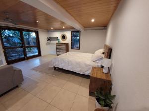 a bedroom with a bed and a table in it at A place to relax in Mudjimba