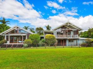 a house with a green lawn in front of it at A place to relax in Mudjimba