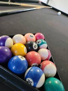 a bunch of billiard balls in a pool table at A place to relax in Mudjimba