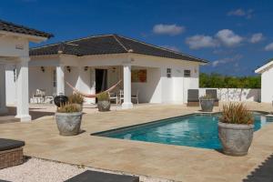 a swimming pool in the backyard of a house at Villa Jewel - Viva Bonaire in Kralendijk