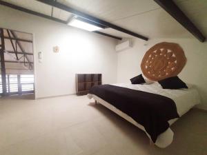 a bedroom with a large bed with a wooden headboard at Loft 5 Montélimar in Montélimar
