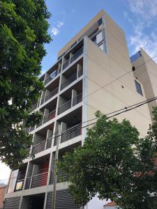 an apartment building with balconies on the side of it at 2 Personas - Balcon, Wifi & Cafe in Santiago del Estero