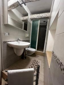 a bathroom with a sink and a toilet at Vicolo Garibaldi in Tropea
