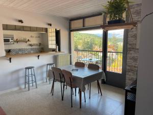 uma cozinha e sala de jantar com mesa e cadeiras em Vue magnifique em Vernet-les-Bains