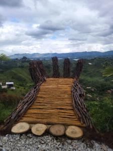 a wooden platform on a hill with a view at San Simon Glamping,El peñol,Guatape in Guatapé