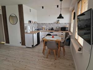 a kitchen with a table and chairs in a room at Apartament Gryfice in Gryfice +6 photos