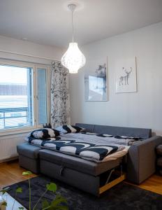 a bedroom with a bed in a room with a window at Aurora Breeze Residence - City Center in Rovaniemi +5 photos