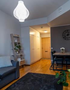 a living room with a couch and a table at Aurora Breeze Residence - City Center in Rovaniemi