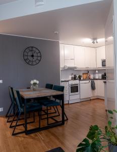 a kitchen and dining room with a table and chairs at Aurora Breeze Residence - City Center in Rovaniemi