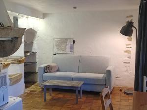 a living room with a couch and a table at Le Montadou Saint Montan in Saint-Montan