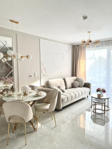 a living room with a couch and a table at LuxApart Apartamenty Jantar in Jantar