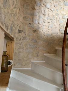 a set of stairs in a stone wall at Charmante petite maison in Saint-Vigor-le-Grand