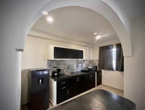 a kitchen with a black refrigerator in a room at Casa Creunza de Mar in Playa del Carmen