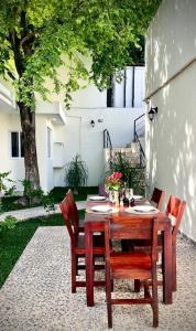 a wooden table and chairs on a patio at Casa Creunza de Mar in Playa del Carmen