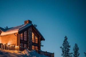 a log cabin with snow on the side of it at Idre Mountain Lodge dream with outdoor Jacuzzi ! in Idre