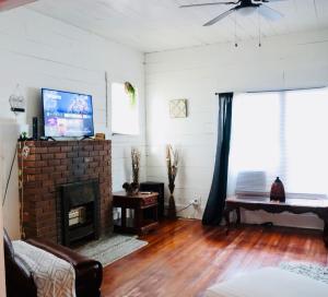 a living room with a fireplace and a tv at Be a part of Kingsville history in Kingsville