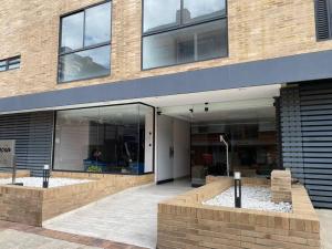 a building with a large glass entryway with a building at Apartamento 2 habitaciones Unicentro Scape in Bogotá