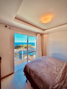 a bedroom with a bed and a large window at Condomínio Encantador - Beto Carrero - 3 quartos in Penha +24 photos