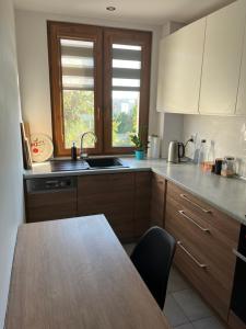 a kitchen with a table and a sink and a window at Komfortowe mieszkanie in Ostrowiec Świętokrzyski