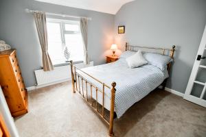 a bedroom with a bed and a window at Charming Malvern Cottage with Outstanding Views in Malvern Wells