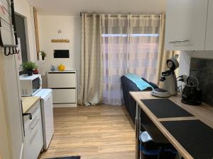 a small room with a bed and a kitchen at My Little Home in Varennes-le-Grand