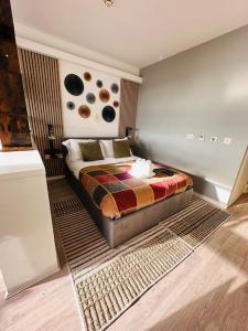 a bedroom with a bed with a rug in it at Luxury Studio Apartment The Cube Birmingham City Centre in Birmingham